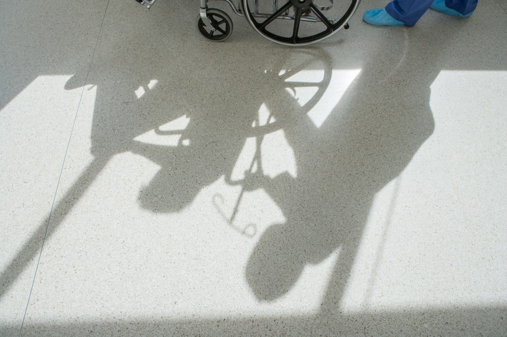 Shadow of woman pushing woman in a wheelchair