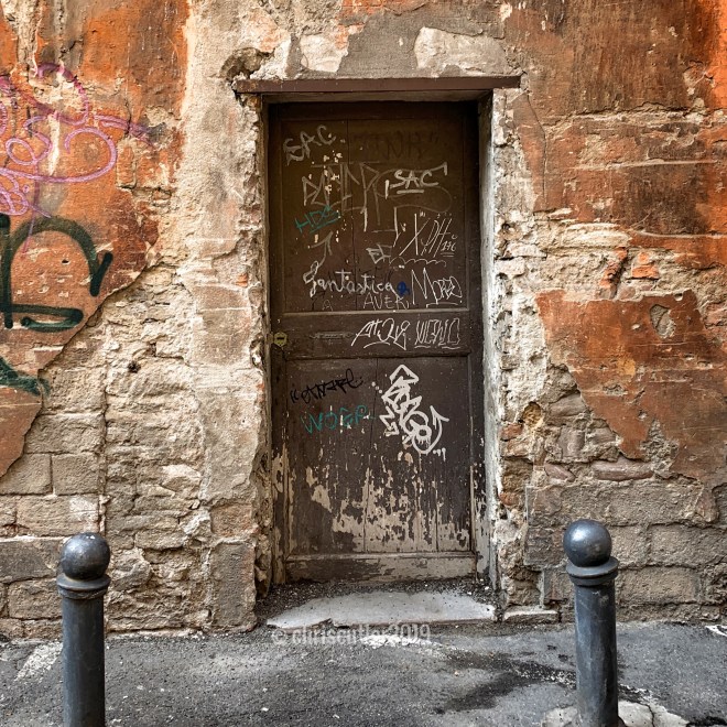Brown door covered in graffiti