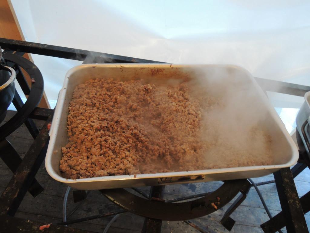 A pan of crumbled sausage sitting on a stove